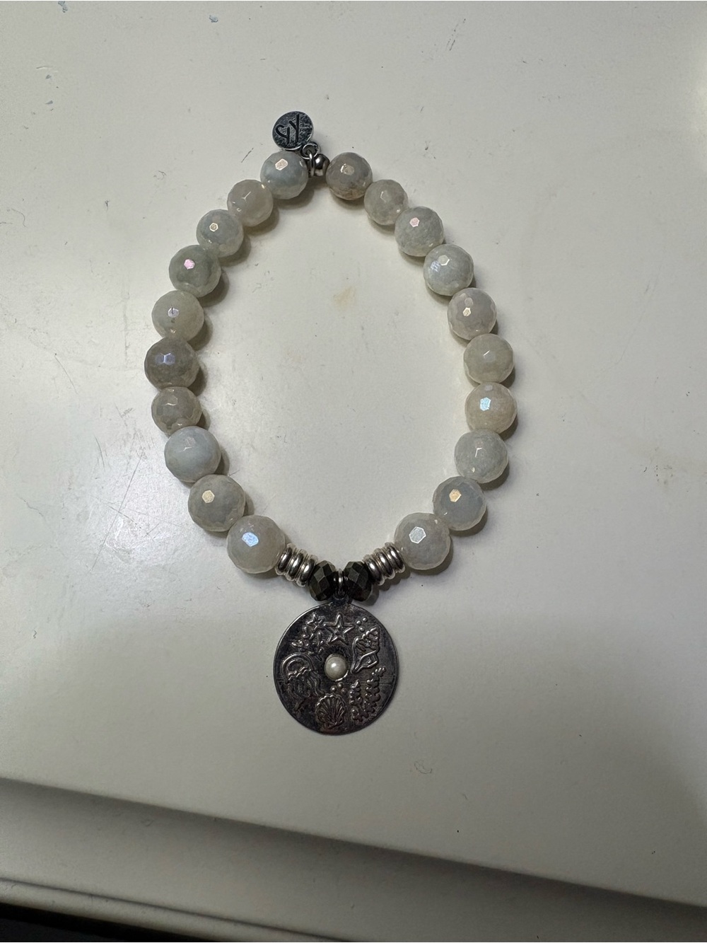 Faceted Cream Bead Bracelet with Decorative Silver Medallion